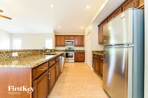 a kitchen with stainless steel appliances and granite counter tops