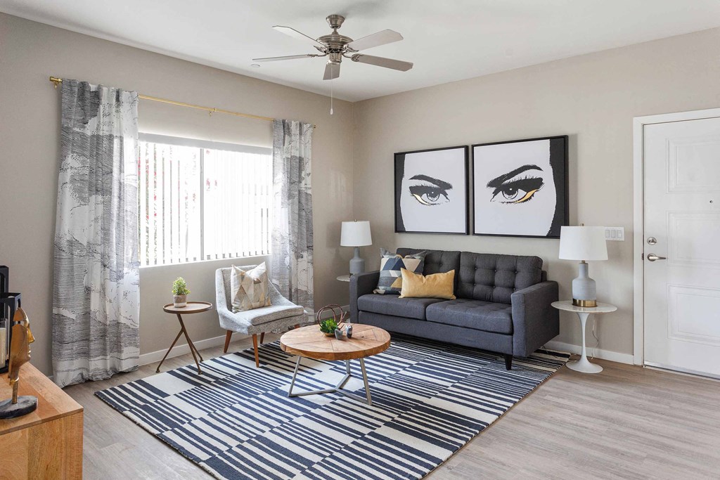 a living room with a couch and a ceiling fan