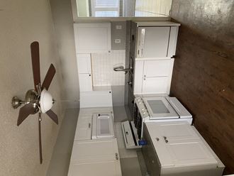 an overhead view of a kitchen with white appliances and a ceiling fan