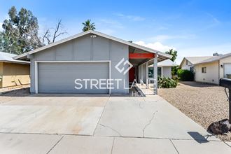 a home with a driveway and a garage door with a sign on it