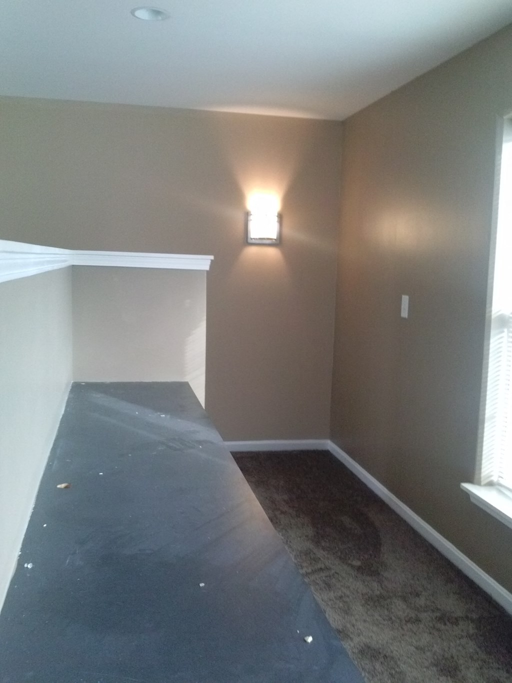 a living room with a table in the corner of a room