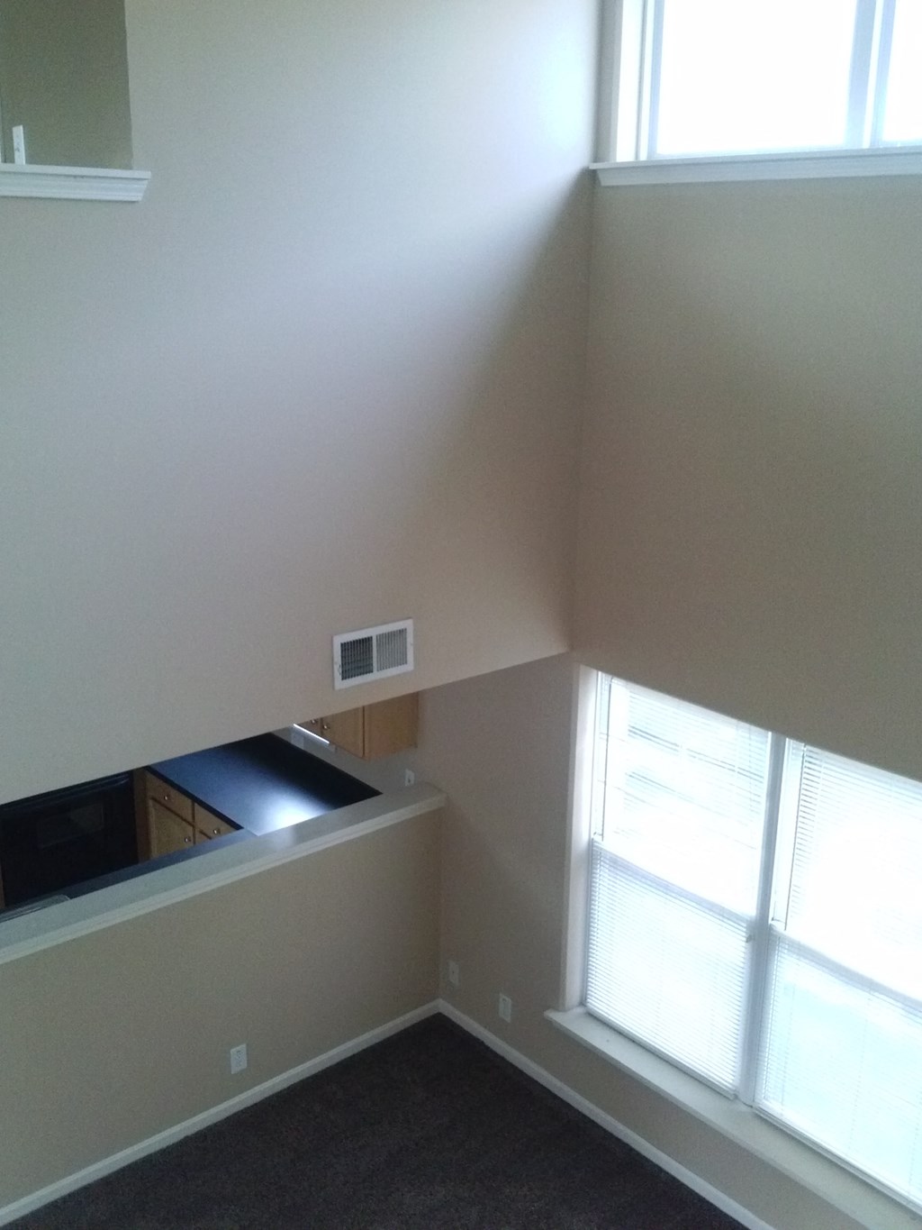 an empty room with a window and a counter