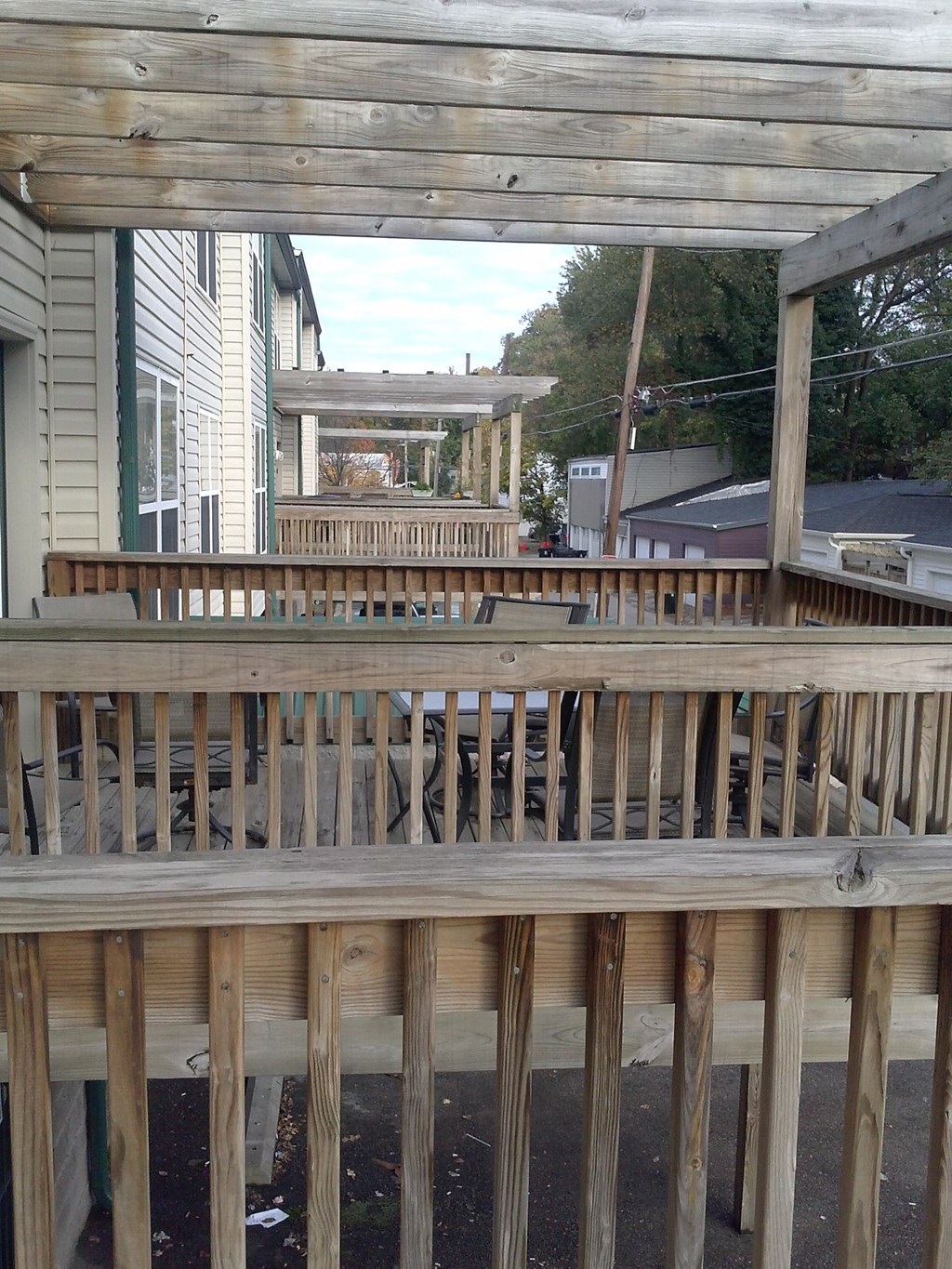 a deck with a gazebo on the side of a house