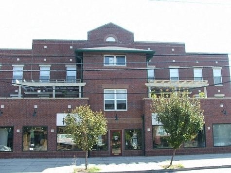 a red brick building with trees in front of it