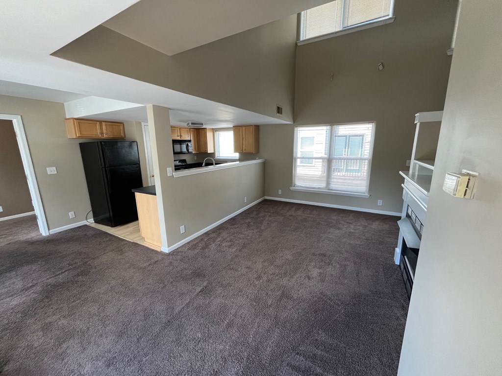 an empty living room and kitchen in an empty house
