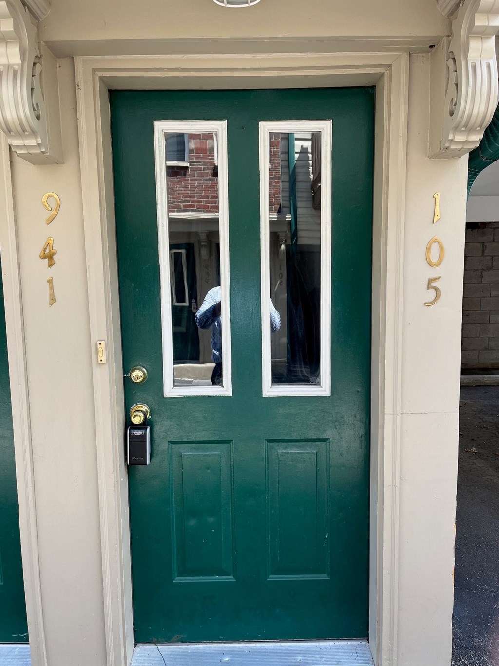 the front door of a house with a green door and windows