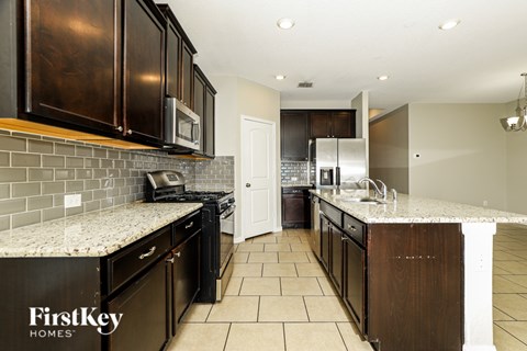 A kitchen with a tile floor and a white counter top.