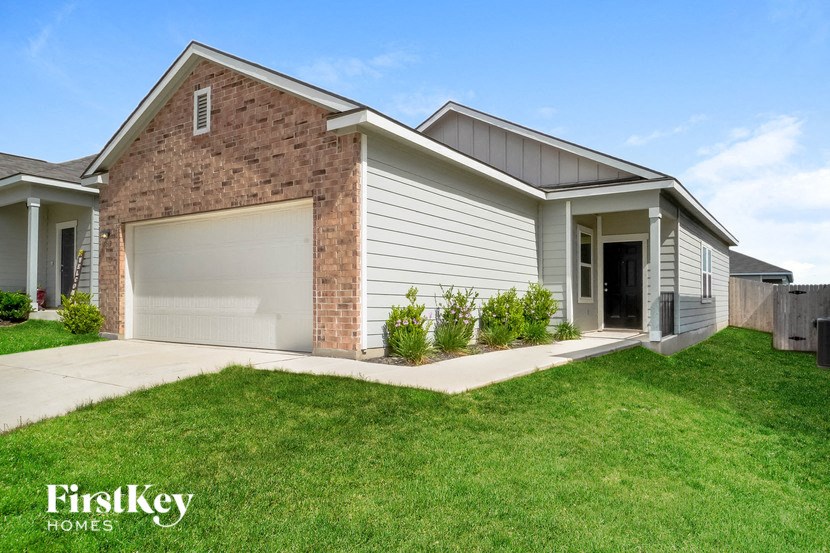 a house with a garage door and a lawn