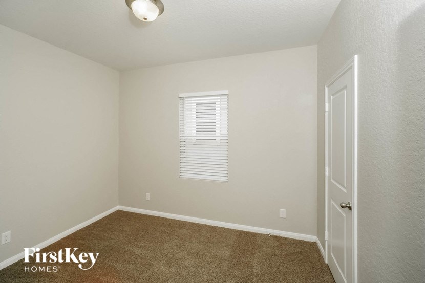 an empty room with a door and a window