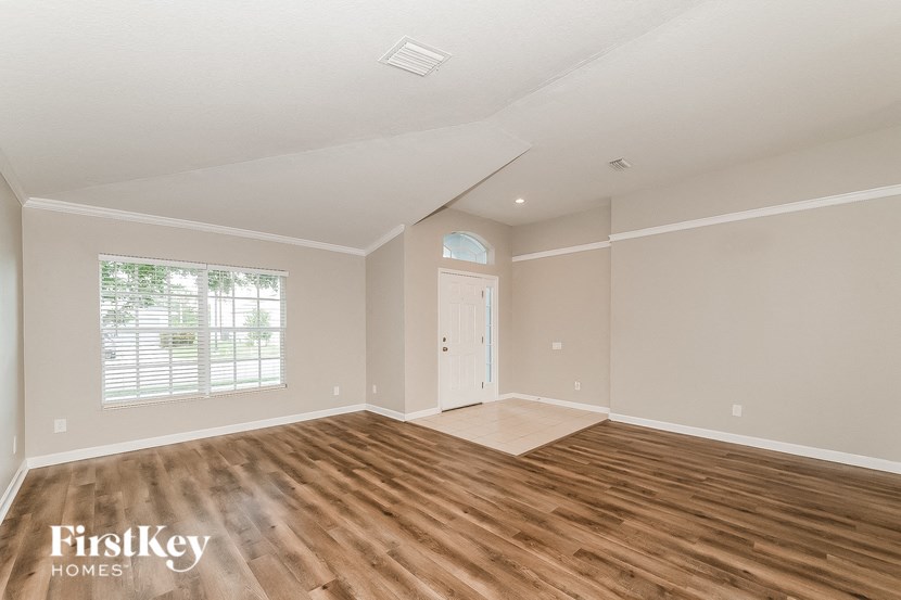 the living room with hardwood floors and a white door