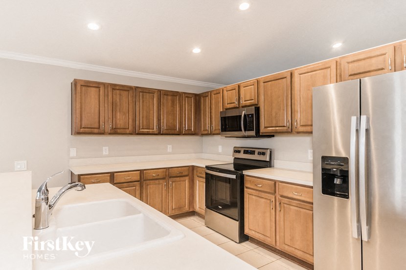 a kitchen with wooden cabinets and stainless steel appliances