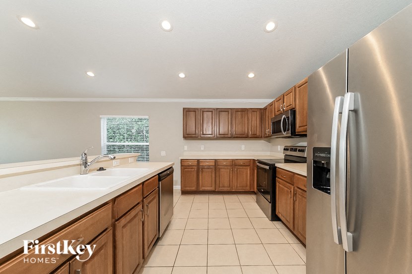 a kitchen with wooden cabinets and stainless steel appliances
