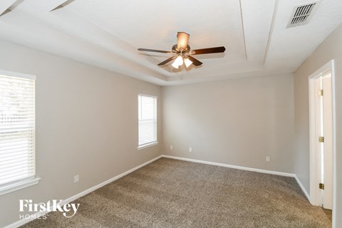 the living room of a home with a ceiling fan