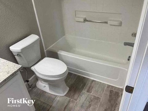 a bathroom with a toilet and a bath tub
