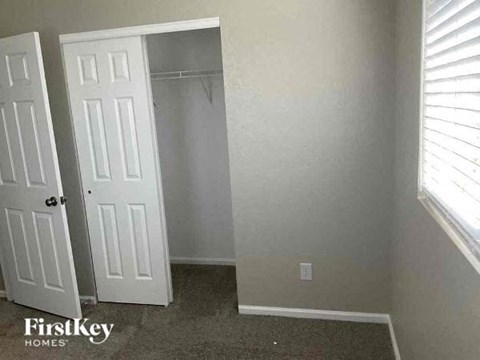 an empty room with a white door and a closet