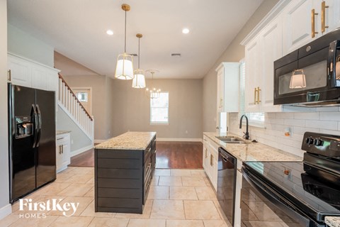 a kitchen with stainless steel appliances and marble counter tops