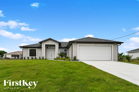 a house with a garage door and a lawn
