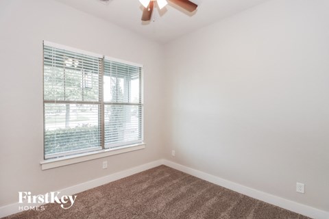 the living room of an empty home with a large window