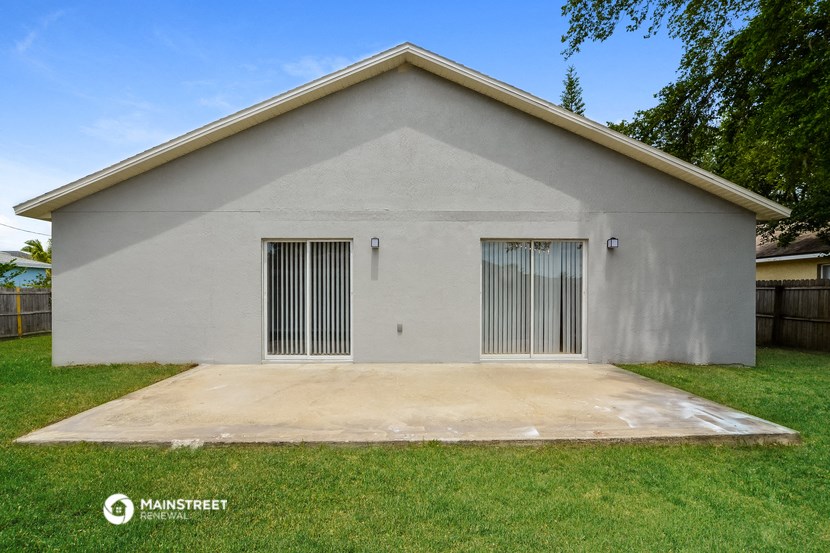 the outside of a house with two garage doors and a driveway