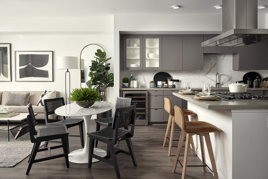 a kitchen and dining area with a table and chairs
