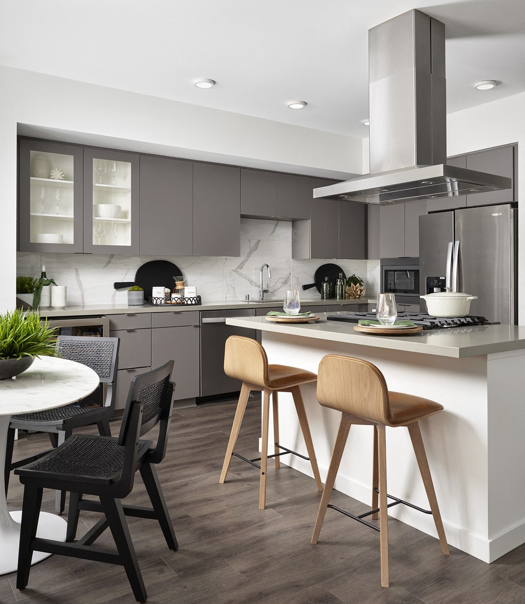 a kitchen with an island and a table with chairs