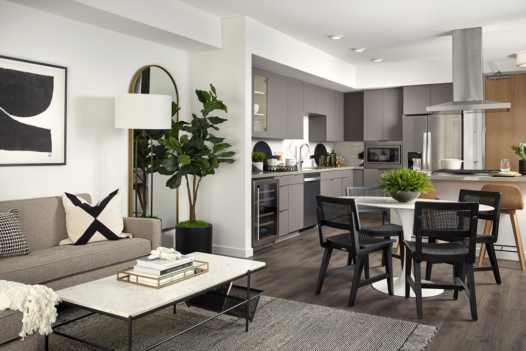 a living room and kitchen with a table and chairs