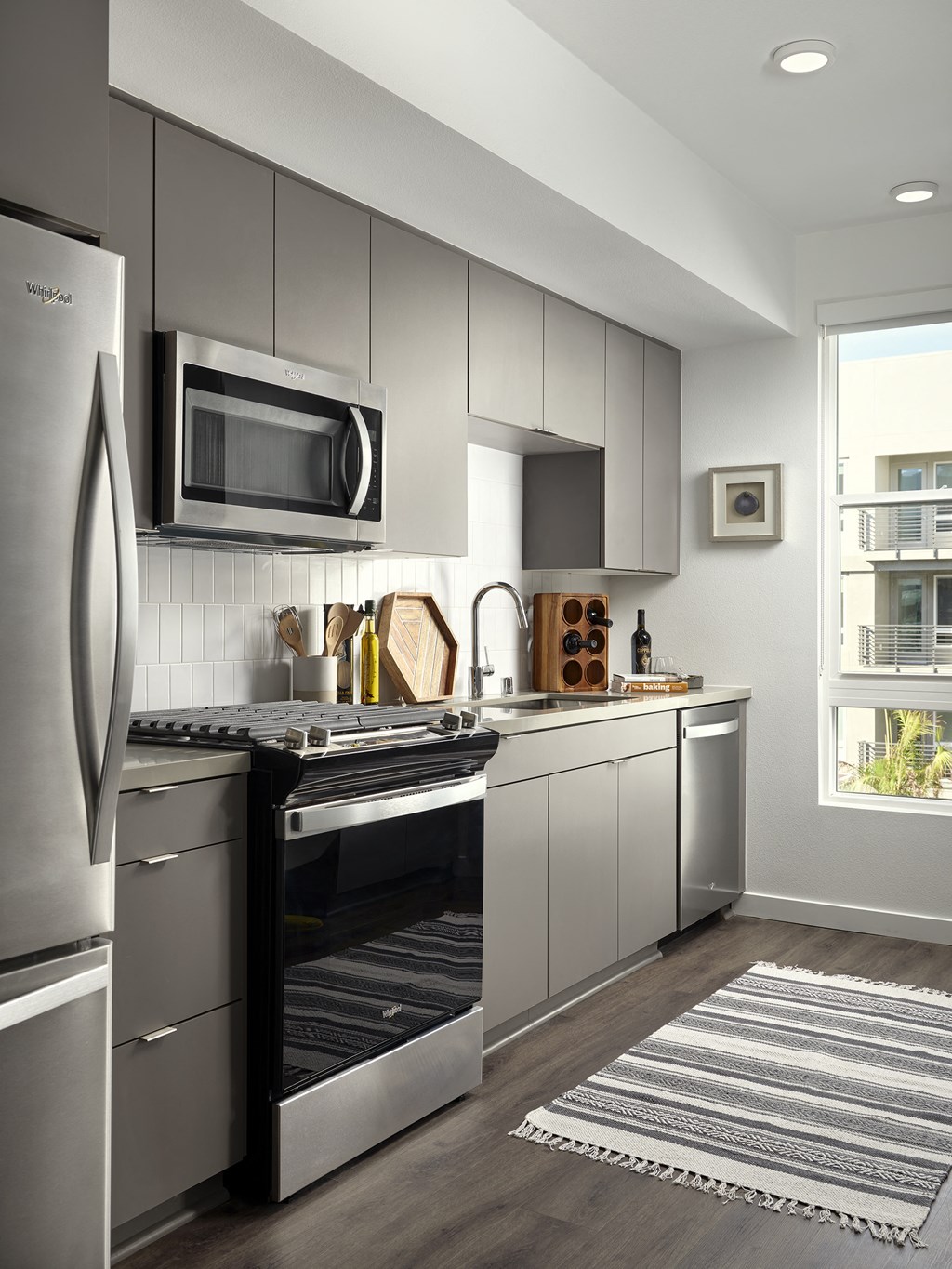 a kitchen with stainless steel appliances and a window
