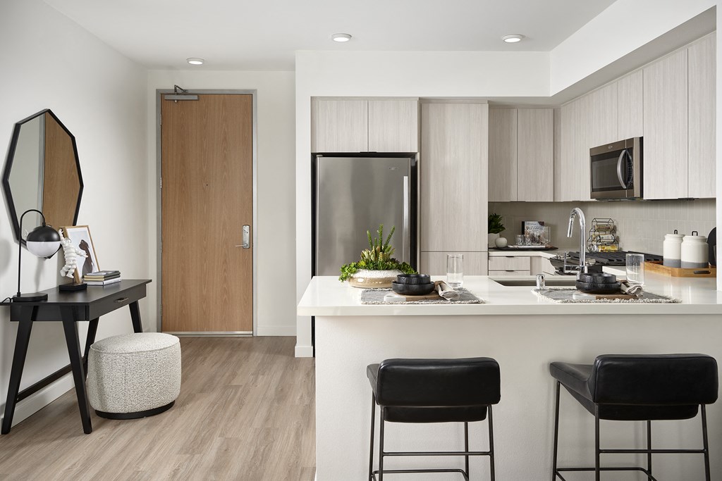 a kitchen with a white counter top and a sink