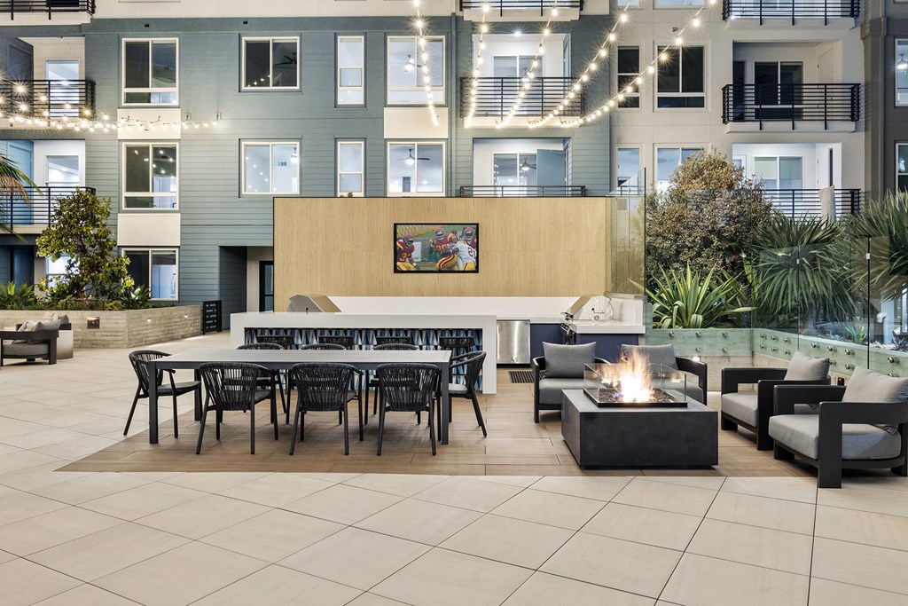 an outdoor area with tables and chairs and a fireplace