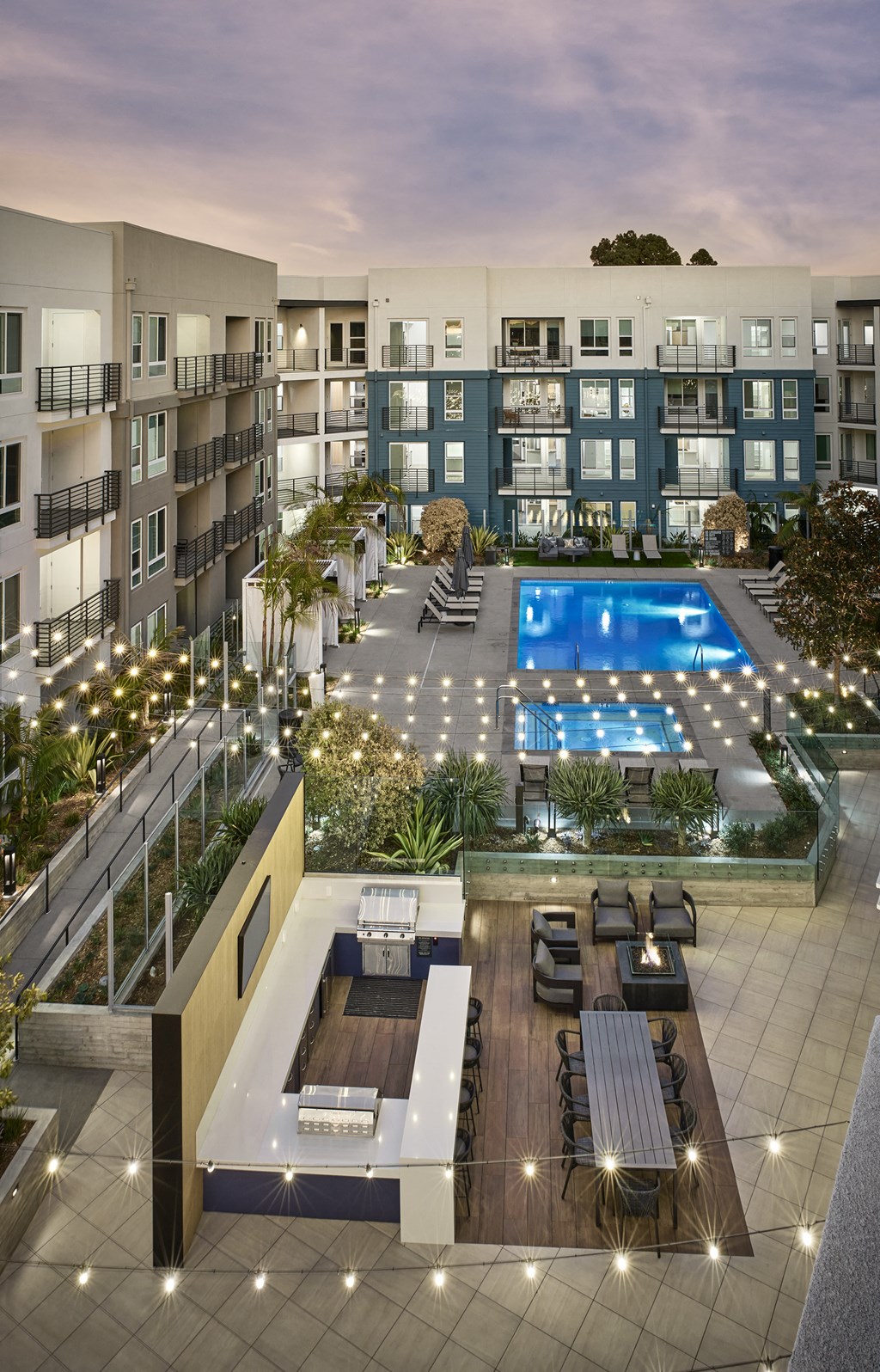 an aerial view of an apartment building with a swimming pool