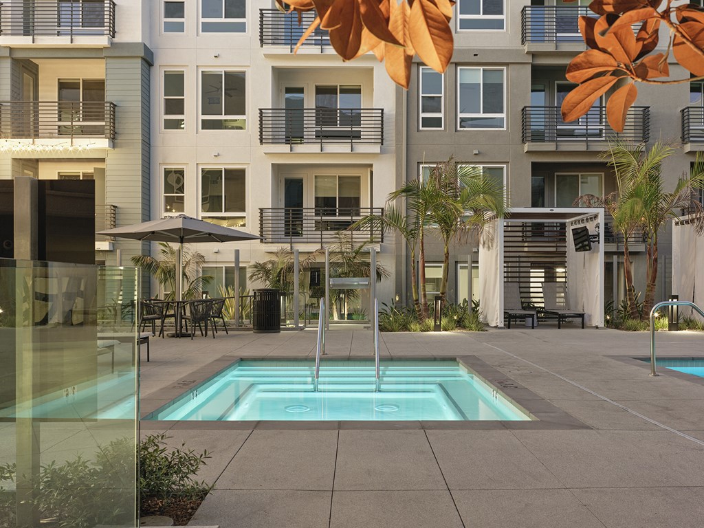 a swimming pool in front of an apartment building