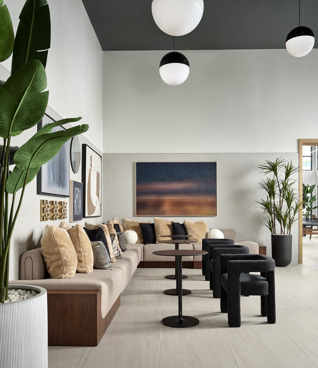 a living room with a long couch and a table with chairs