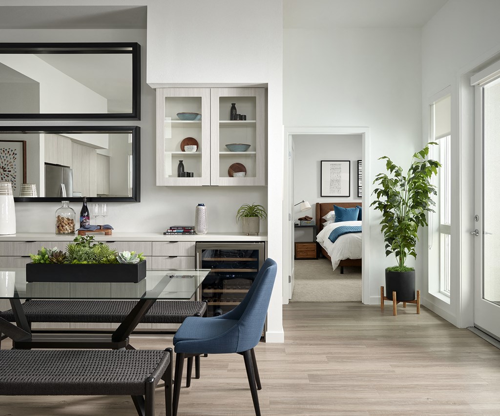 a living room and dining room with a table and chairs