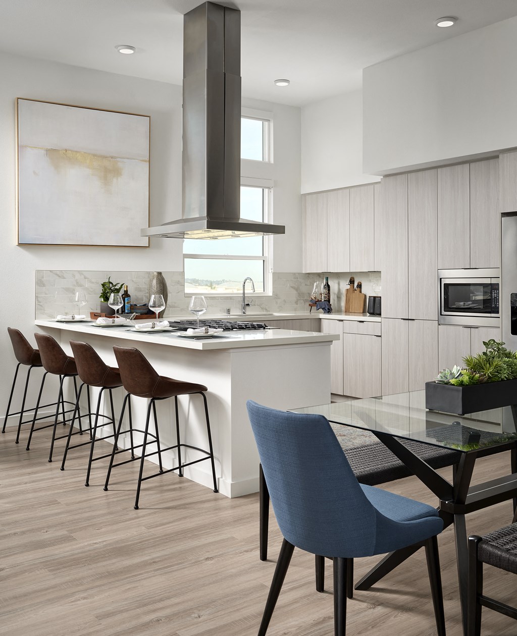 a modern kitchen with a dining area and a table with chairs