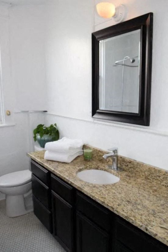 a bathroom with a sink and a mirror and a toilet