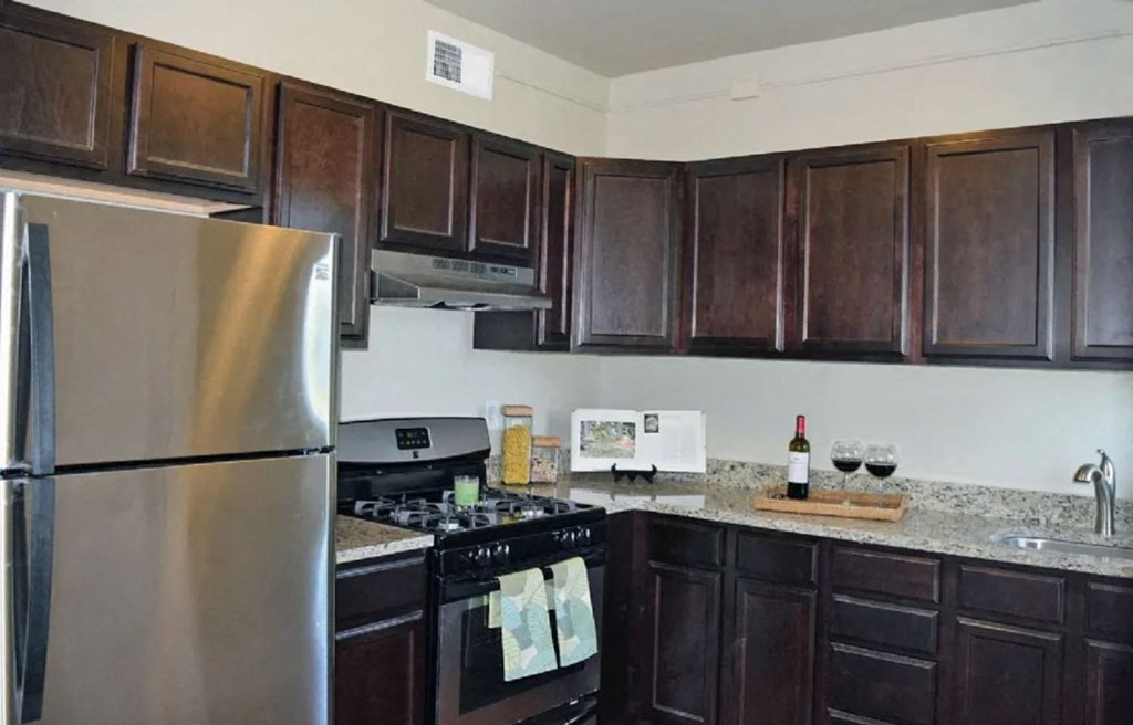 a kitchen with stainless steel appliances and wooden cabinets