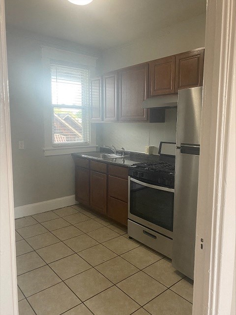 a small kitchen with a stove and a refrigerator