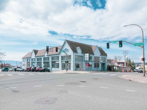 A street view of a building with a green traffic light.