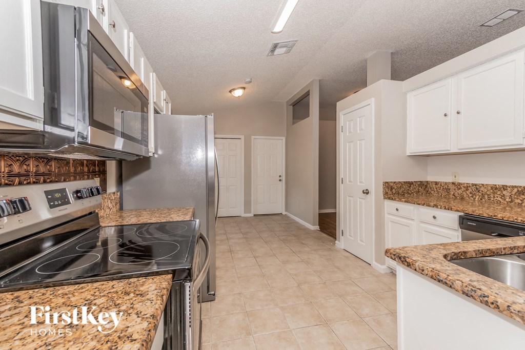 a kitchen with stainless steel appliances and granite counter tops