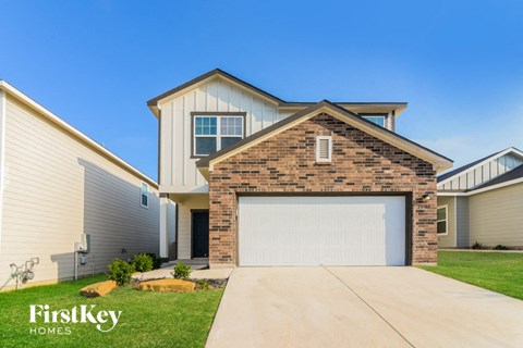 a house with a garage door in front of it