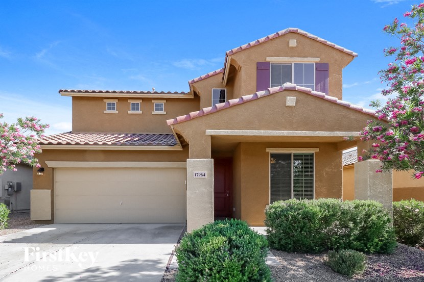 a beige house with a garage and a driveway