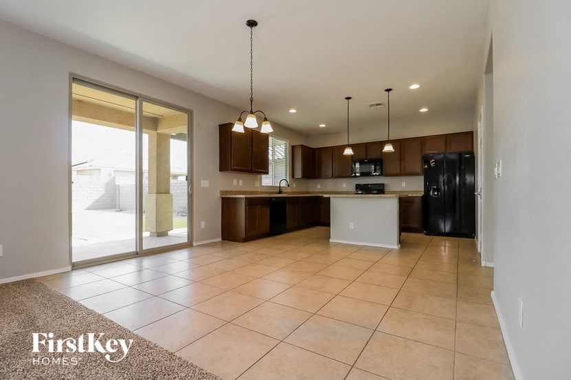 an open kitchen and living room with a sliding glass door