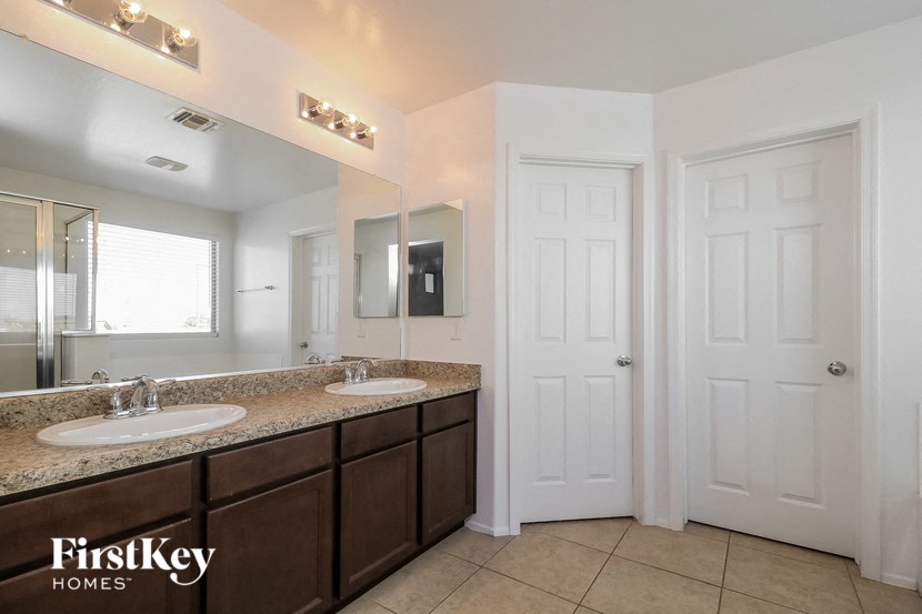 a bathroom with two sinks and a mirror