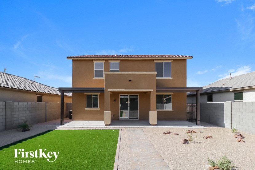 a house with a driveway and a lawn in front of it