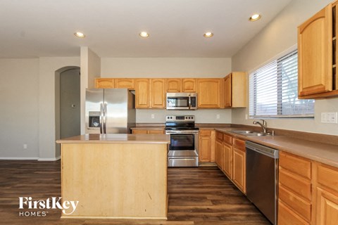 a kitchen with wooden cabinets and stainless steel appliances