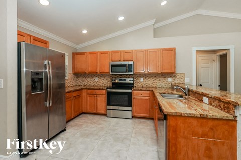 a kitchen with wooden cabinets and stainless steel appliances