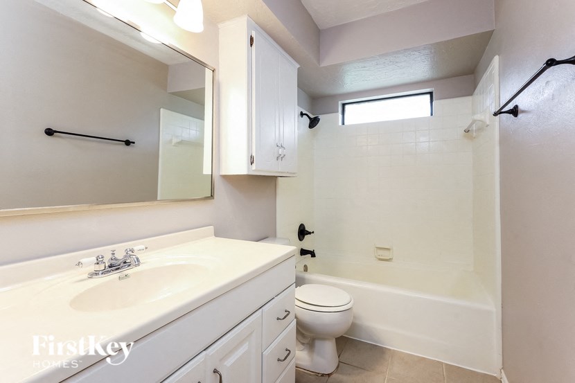 a bathroom with a sink and a toilet and a tub