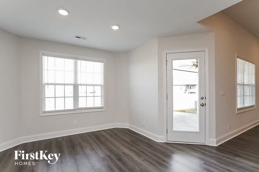 an empty room with a door and a window
