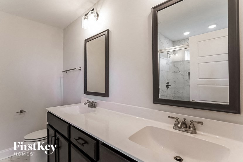 a white bathroom with a sink and a mirror