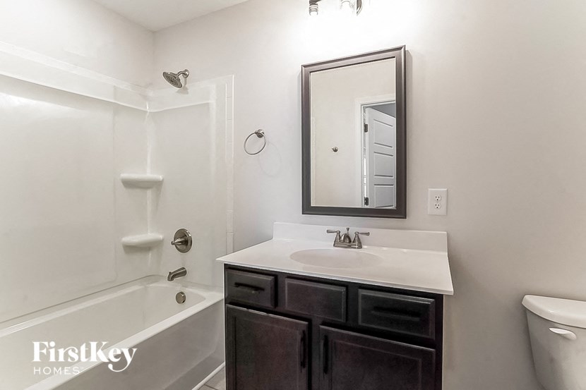 a white bathroom with a sink and a mirror